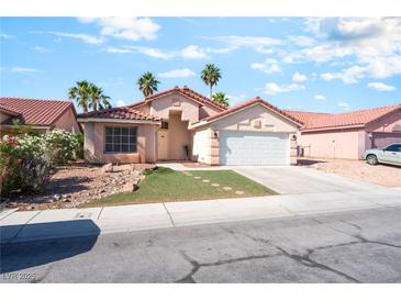 Charming single-story home with a well-maintained lawn, desert landscaping, and two-car garage at 517 Casa Del Norte Dr, North Las Vegas, NV 89031