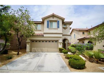 Charming two-story home featuring a well-maintained yard and attached two-car garage in a suburban neighborhood at 9144 Clear Sky Ave, Las Vegas, NV 89178