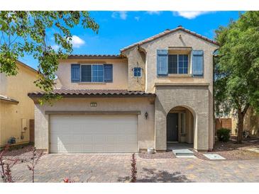 Charming two-story home with a two-car garage, desert landscaping, and blue window shutters at 928 Shades End Ave, North Las Vegas, NV 89081