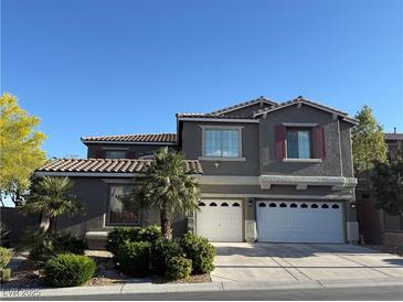 Charming two-story home with a terracotta tile roof, two-car garage, and low-maintenance landscaping at 10009 Madison Walk Ave, Las Vegas, NV 89149