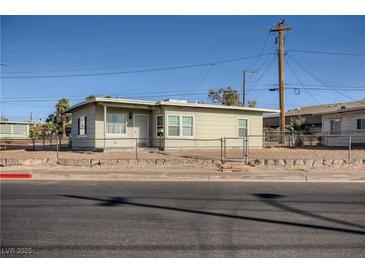 Charming single-story home featuring a fenced yard and well-maintained landscaping at 103 W Victory Rd, Henderson, NV 89015