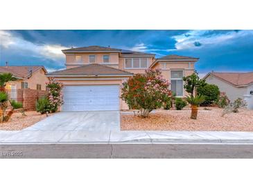 Charming two-story home featuring a two-car garage, desert landscaping, and beautiful flowering trees at 1367 Minuet St, Henderson, NV 89052