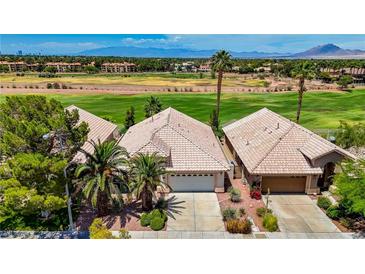 Charming single-story home features lush landscaping, mature trees, and a tile roof against a green golf course at 2149 Eaglepath Cir, Henderson, NV 89074