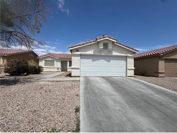 Charming single-story home featuring a two-car garage and low-maintenance desert landscaping at 2916 Honeysuckle Ave, North Las Vegas, NV 89031