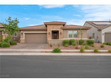 Charming single-story home showcasing a desert-landscaped yard and a two-car garage at 398 Frank Case Ln, Henderson, NV 89011