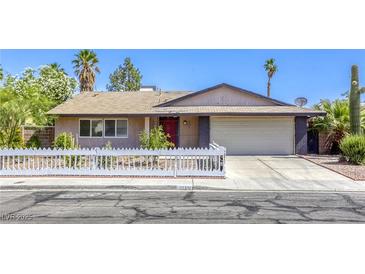 Charming single-story home with a white picket fence and desert landscaping at 5132 Springland St, Las Vegas, NV 89146