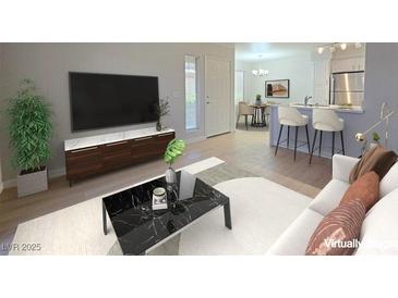 Bright living room with modern furniture and decor, adjacent to the open-plan kitchen at 5710 E Tropicana Ave # 1018, Las Vegas, NV 89122