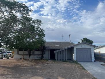 Charming single-story home featuring mature tree, attached garage, and desert landscaping in a quiet neighborhood at 5920 Glen Eagles Ln, Las Vegas, NV 89108