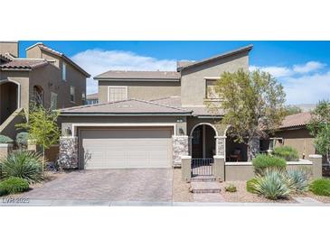 Beautiful two-story home featuring a two-car garage and landscaped front yard and gated entry at 8 Via Dolcetto, Henderson, NV 89011