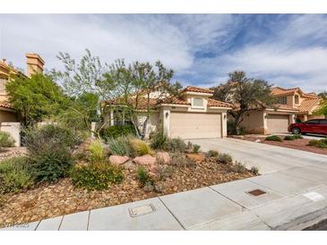 Charming single-story home with a well-manicured desert landscape and a two-car garage at 1632 Royal Canyon Dr, Las Vegas, NV 89128