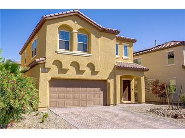 Charming two-story home with a two-car garage, desert landscaping, and a welcoming front entrance at 320 Point Loma Ave, North Las Vegas, NV 89031