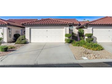 Charming single-story home with a two-car garage and well-manicured landscaping at 450 Intrepid Ct, Boulder City, NV 89005