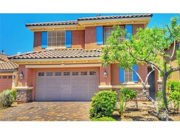 Charming two-story home featuring a tile roof, blue shutters, and a well-maintained front yard at 10279 Montes Vascos Dr, Las Vegas, NV 89178