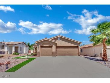 Charming single-story home boasts a stucco exterior, two-car garage, and well-manicured landscaping at 2558 Wiltshire Ave, Henderson, NV 89052