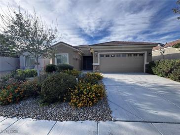 Charming single-story home with desert landscaping and a two-car garage in a quiet neighborhood at 3124 Kookaburra Way, North Las Vegas, NV 89084
