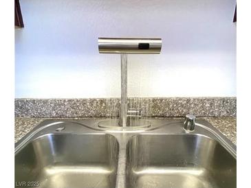 Stainless steel kitchen sink with modern, touchless faucet and stylish countertop at 4421 Alexis Dr # 429, Las Vegas, NV 89103