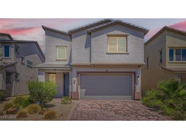 Charming two-story home featuring desert landscaping and a two-car garage at 5947 Wellington Peak Rd, Las Vegas, NV 89148
