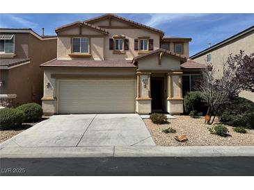 Two-story home featuring tan siding, desert landscaping, and an attached two-car garage at 10118 Farmington Hall Ct, Las Vegas, NV 89129