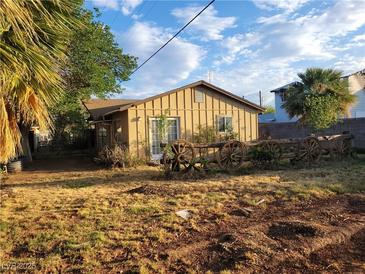 Charming single-story home with rustic wagon wheel accents and mature trees at 165 W Alma Ave, Overton, NV 89040