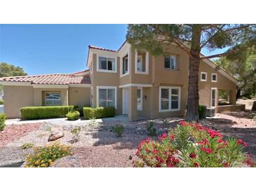 Charming home featuring a well-manicured lawn and colorful flower beds at 2033 Summer Spruce Pl # 102, Las Vegas, NV 89134