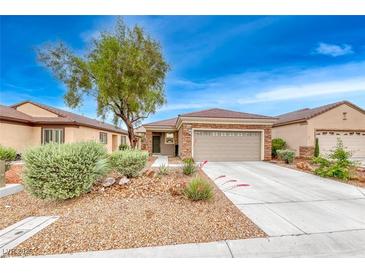 Charming single-story home with a well-manicured front yard and a two-car garage at 2522 Darda St, Henderson, NV 89044