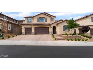 Charming two-story stucco home features a three-car garage and well-manicured landscaping at 2575 Hazelburn Ave, Henderson, NV 89044