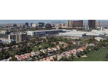 Scenic aerial view of a golf course community with the city skyline in the background at 3111 Bel Air Dr # 28A, Las Vegas, NV 89109