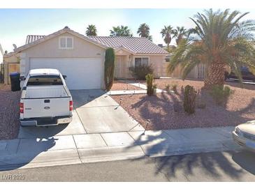 Charming single-story home with desert landscaping, mature palms, and a two-car garage at 4704 Wild Oak Way, North Las Vegas, NV 89031