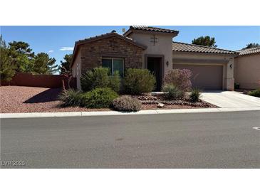 Charming single-story home with stone accents, desert landscaping, and a two-car garage at 5235 E La Campana Dr, Pahrump, NV 89061