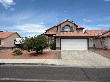 Charming two-story home with a well-maintained front yard and a spacious two-car garage at 5517 Rock Creek Ln, Las Vegas, NV 89130