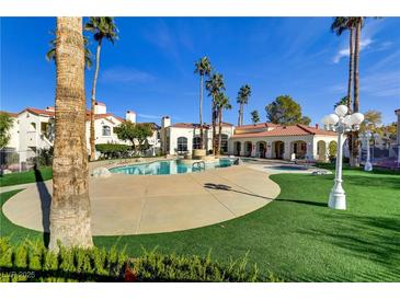 Inviting community pool surrounded by lush landscaping and palm trees on a sunny day at 698 S Racetrack Rd # 1714, Henderson, NV 89015