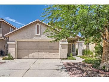 Charming single-story home with a two-car garage and a well-maintained front yard at 8242 Tribute Ln, Las Vegas, NV 89147