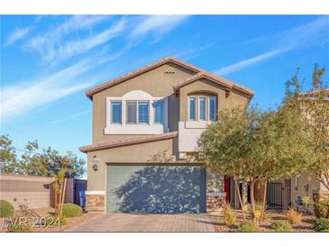 Charming two-story home featuring a two-car garage and well-maintained landscaping, set against a bright blue sky at 9208 S Park St, Las Vegas, NV 89178