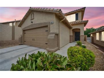 Inviting single-Gathering home featuring a two-car garage, desert landscaping, and a covered front entry at 10952 Napa Ridge Dr, Las Vegas, NV 89144