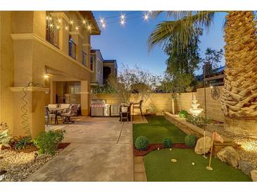 Outdoor living space featuring a mini golf course, grill, fountain, and outdoor seating under decorative string lights at 1272 Olivia Pkwy, Henderson, NV 89011