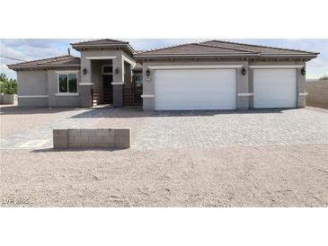 Charming single-story home featuring a two-car garage, gated entry and desert landscaping at 197 E Shelbourne Ave, Las Vegas, NV 89123