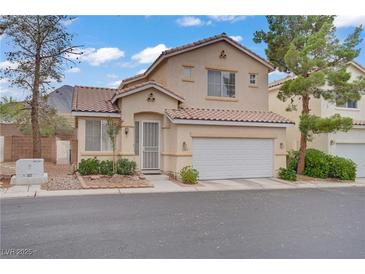 Charming two-story home features a well-maintained front yard, two-car garage, and a red tile roof at 3205 Rainmaker St, Las Vegas, NV 89129