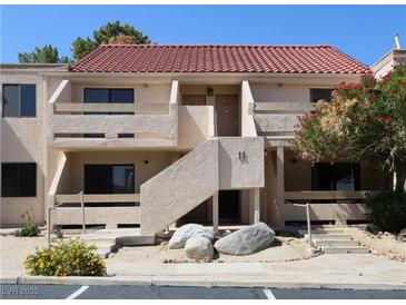 Charming condo featuring a red tile roof, a private balcony, and a quaint desert landscape at 3811 Desert Marina Dr # 125, Laughlin, NV 89029