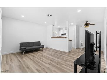 Inviting living room with neutral tones and modern, light-colored, wood-look flooring at 3923 Gogo Way # 106, Las Vegas, NV 89103