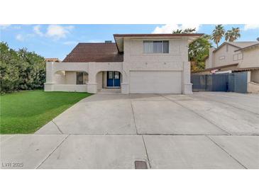 Charming two-story home featuring a spacious driveway, well-maintained lawn, and a unique architectural design at 4330 Flandes St, Las Vegas, NV 89121