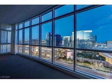 Spacious living room featuring floor-to-ceiling windows with panoramic city views and natural light at 4575 Dean Martin Dr # 2607, Las Vegas, NV 89103