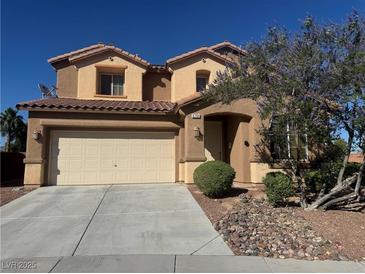 Charming two-story home features a two car garage and landscaped front yard under a clear blue sky at 6756 Sea Swallow St, North Las Vegas, NV 89084