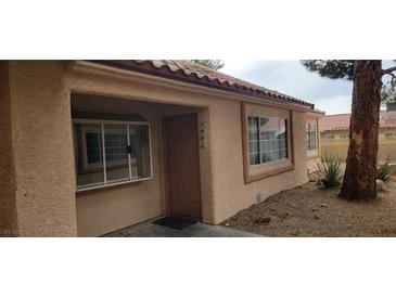Home exterior featuring a tan stucco finish, red tile roof, and inviting front entrance at 1612 N Torrey Pines Dr # 104, Las Vegas, NV 89108