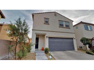 Charming two-story home featuring a neutral color scheme, a two-car garage, and neat landscaping at 3688 Via Mariposa Ave, Las Vegas, NV 89115
