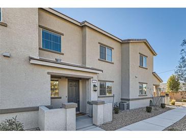 Charming two-story home with tan stucco, covered front porch, and well-maintained landscaping at 762 Star Estates Ave # 0, North Las Vegas, NV 89086