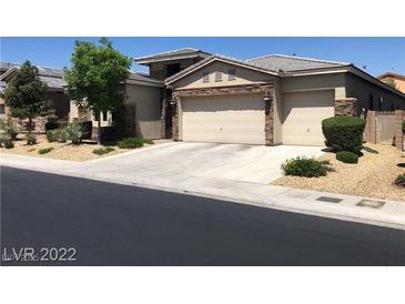 Contemporary home featuring a three-car garage and desert landscaping at 7934 Cape Flattery Ave, Las Vegas, NV 89147