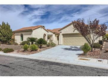 Charming single-story home featuring a tile roof, desert landscaping, and an attached two-car garage at 2148 Shadow Canyon Dr, Henderson, NV 89044