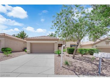 Charming single-story home with a two-car garage and meticulously xeriscaped front yard at 2323 Barbers Point Pl, Las Vegas, NV 89134