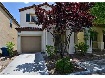 Charming two-story home featuring a well-manicured front yard and attached garage at 7089 Oberling Bay Ave, Las Vegas, NV 89113