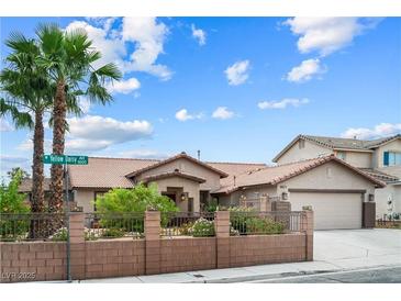 Charming single-story home featuring mature palm trees and a well-manicured front yard at 8021 Yellow Daisy Ave, Las Vegas, NV 89147